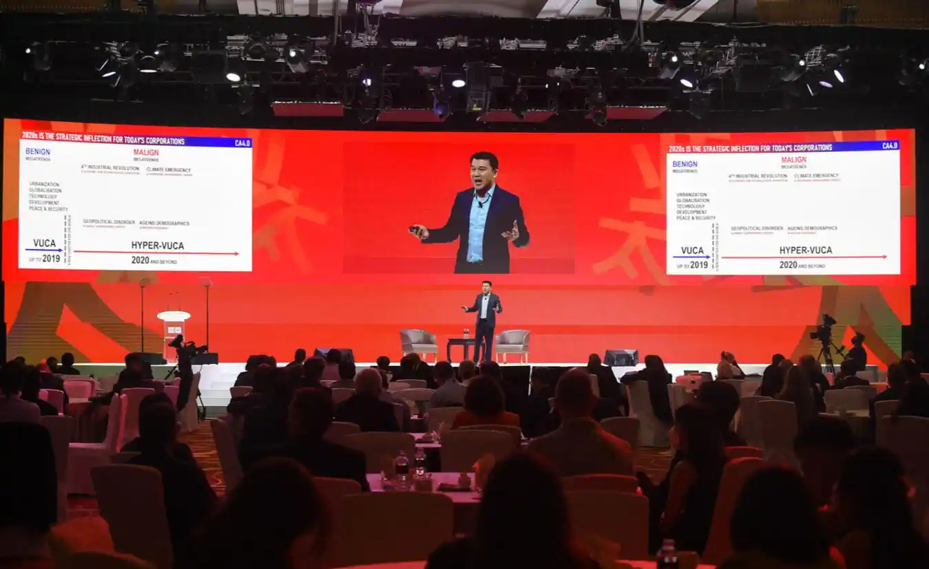 Charlie Ang on stage discussing hyper-VUCA